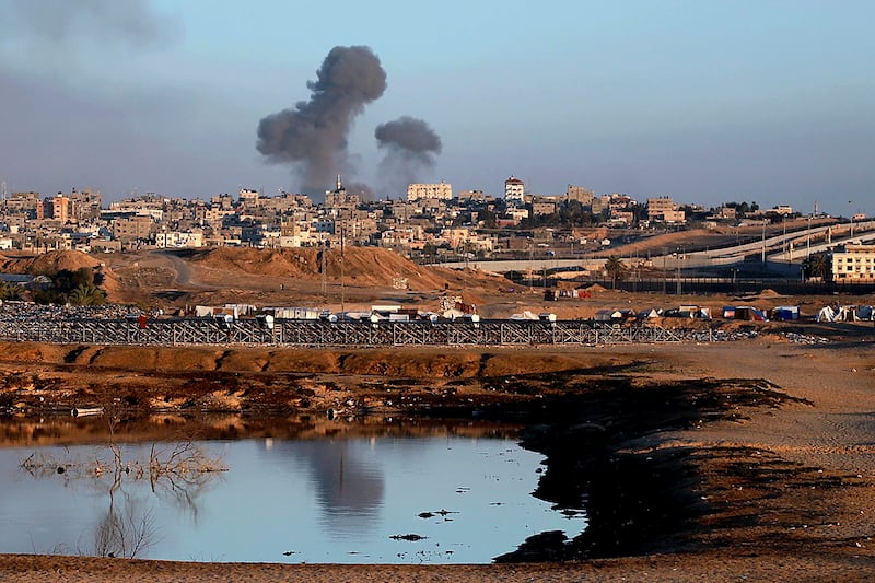 Smoke rises following an Israeli airstrike on buildings near the separating wall between Egypt and Rafah. Photograph: Ramez Habboub/AP