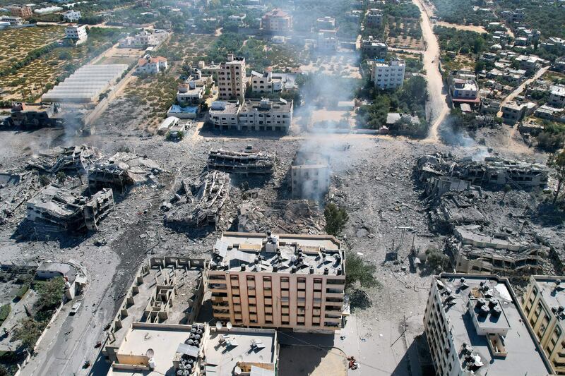 An aerial view shows smoke rising amid destoyed buildings in al-Zahra city, south of Gaza City, on Friday following Israeli bombardment overnight. Photograph:  Belal Alsabbagh/AFP/Getty 