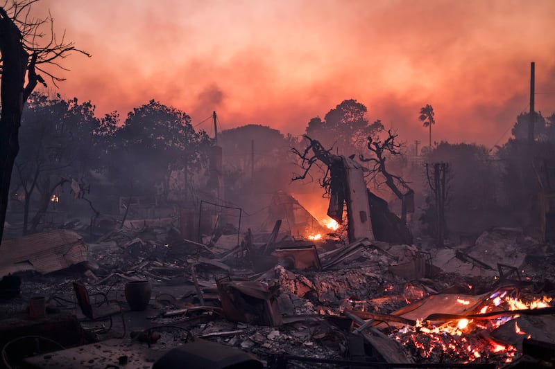 Fires continue to burn in a neighborhood around sunset time in the Pacific Palisades area of Los Angeles on January 8th. Photograph: Mark Abramson/The New York Times
                      