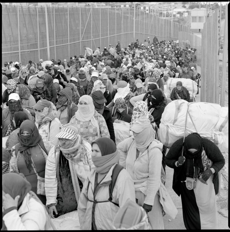 Hundreds of women arrive to carry goods across the border from Monday to Thursday at Barrio Chino, Melilla