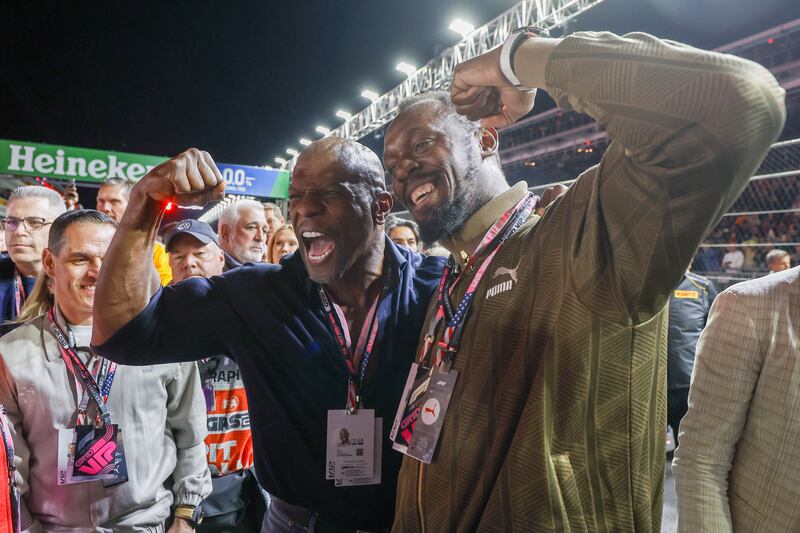 American actor and television host Terry Crews with Jamaican sprinter Usain Bolton the grid prior to the Las Vegas Grand Prix. Photograph: Caroline Brehman/EPA