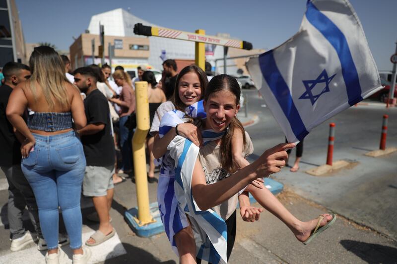 People celebrate outside Tel HaShomer Hospital in Tel Aviv at the weekend, where the four hostages rescued from Hamas captivity by Israeli special forces were being treated. Photograph: Abir Sultan/EPA