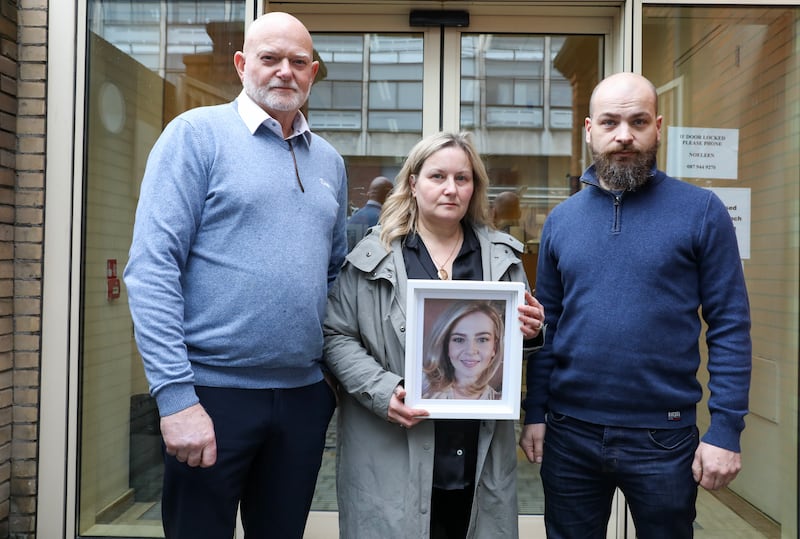 Chris, Alison and Gregory Sainsbury hold a photo of Byronny Sainsbury
outside the Coroners Court  on Store Street, Dublin.  Photograph: Gareth Chaney/Collins
