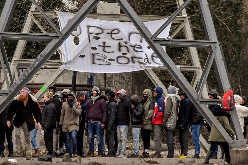 Open the border: migrants queue for food from a charity in Calais. More have been attracted to the city by talk of reunification with family members in Britain and French pressure on the UK to accept more unaccompanied children. Photograph:Philippe Hugen/AFP/Getty