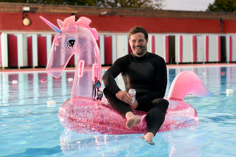 Jamie Dornan: The new face of Diet Coke floats around on a pink inflatable unicorn