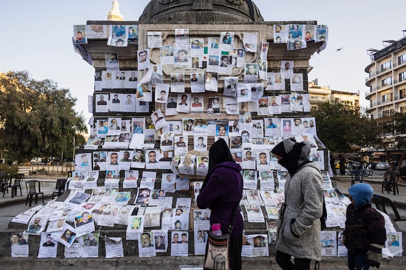 Posters of missing people hang on a monument in the centre of Marjeh Square in Damascus on December 26th. Photograph: Sameer Al-Doumy/AFP via Getty