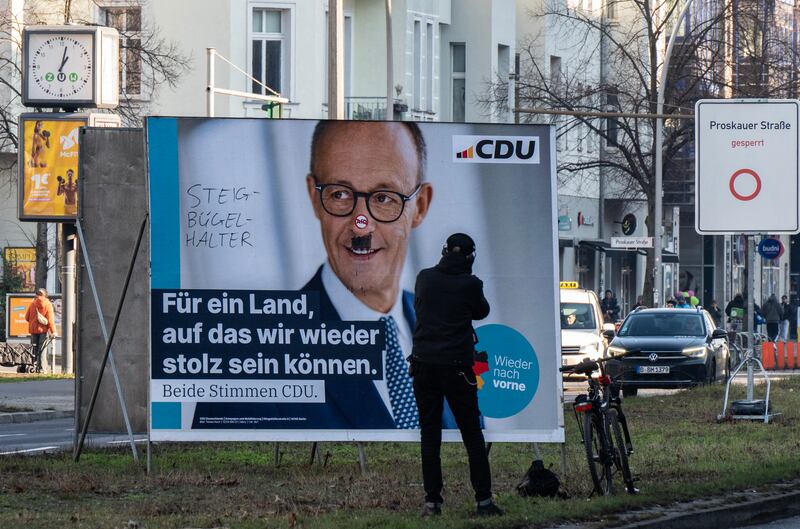 A defaced election campaign poster featuring the Christian Democratic Union's main candidate, Friedrich Merz, in Berlin. Photograph: John Macdougall/AFP/Getty