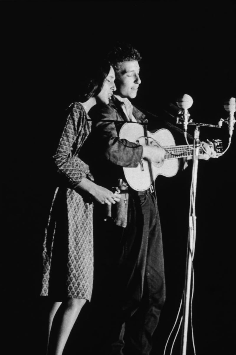 Joan Baez and Bob Dylan perform together onstage in 1963. Photograph: Columbia Records/Getty Images