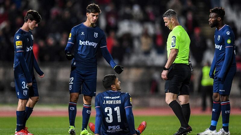 Joao Monteiro sits on the pitch in the second half. Photo: Patricia De Melo Moreira/AFP via Getty Images