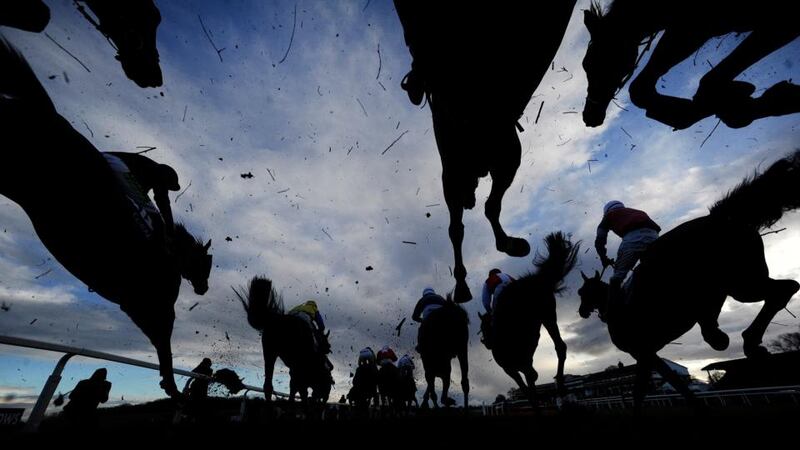 Runners clear a fence in The Coral Welsh Grand National at Chepstow. Photograph:  Alan Crowhurst/Getty Images