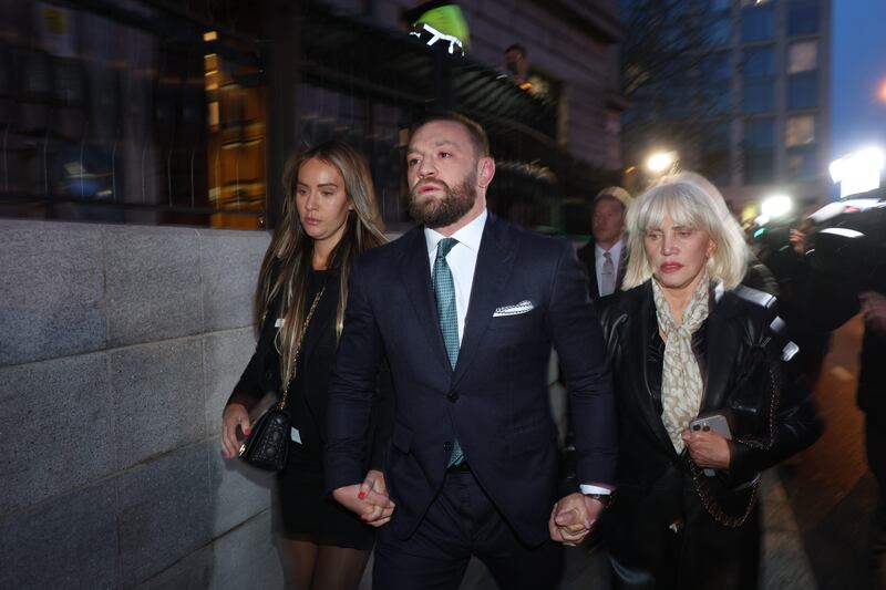 Conor McGregor with his partner Dee Devlin and mother Margaret as they left court. Photograph: Collins Courts 

