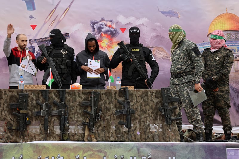 Israeli hostages Averu Mengistu and Tal Shoham flanked by Hamas fighters during their release in Rafah in the southern Gaza Strip. Photograph: Omar Al-Qattaa/Getty Images