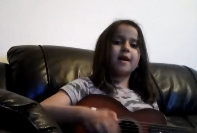 A video grab image issued by Surrey Police of Sara Sharif singing and playing a guitar. Photograph: PA Wire 

