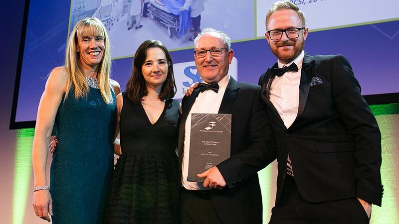 Cathal McGuinness, Director, SAS International presents the Fit Out Project of the Year award to Carole Smillie, Bennett Construction, Maria Mulcahy & Robert Salmon, Henry J Lyons.