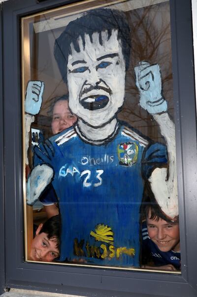 Pupils from sixth class in St Patrick's N.S. in Shercock at their classroom window which has been decorated for Saturday's Dublin v Cavan game. Photo: Crispin Rodwell/The Irish Times