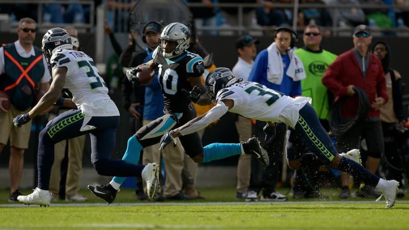 Tre Flowers  of the Seattle Seahawks tackles Curtis Samuel  of the Carolina Panthers. The Seahawks teach rugby-style tackling to their players. Photograph:  Grant Halverson/Getty Images