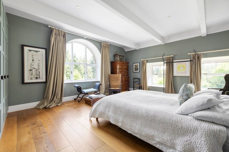 The main bedroom lies upstairs and has a lovely arched window