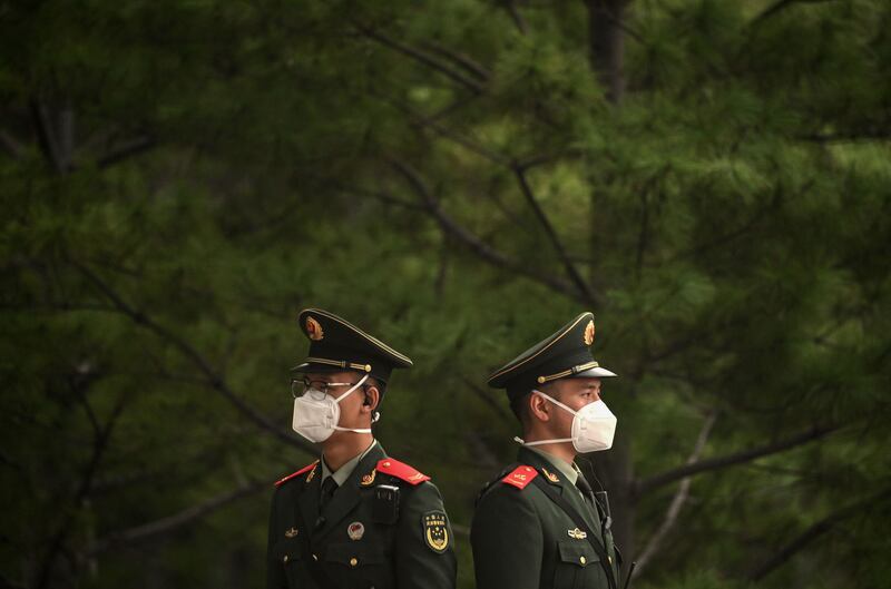 Security personnel stand guard along a highway leading to Tiananmen Gate ahead of China's 20th Communist Party Congress in Beijing. Photograph: Noel Celis / AFP