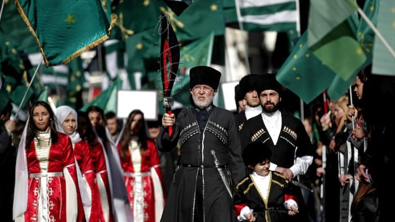 Members of a Circassian ethnic group shout slogans during a protest  in front of the Russian consulate in Istanbul. This year marks the 150th anniversary of the Sochi massacres and deportation of about 500,000 Circassians, and Turkey’s Circassian activists hope to use the Winter Olympics in Sochi draw attention to Russia’s past wrongdoings . Photograph: Sedat Suna/EPA