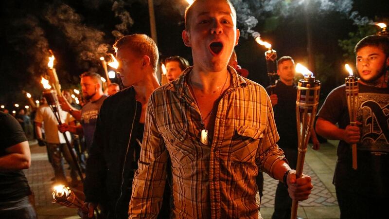 White nationalist groups march with torches through the UVA campus in Charlottesville on Friday. Photograph: Mykal McEldowney/The Indianapolis Star via AP