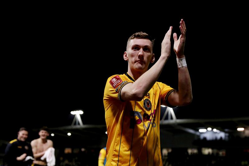 Nathan Wood of Newport County applauds the fans at full-time after defeat to Manchester United. Photograph: Ryan Hiscott/Getty Images