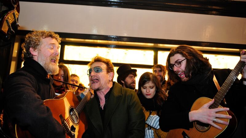 Glen Hansard, Bono and Hozier singing on Grafton Street on Christmas Eve. Photograph: Aidan Crawley/The Irish Times