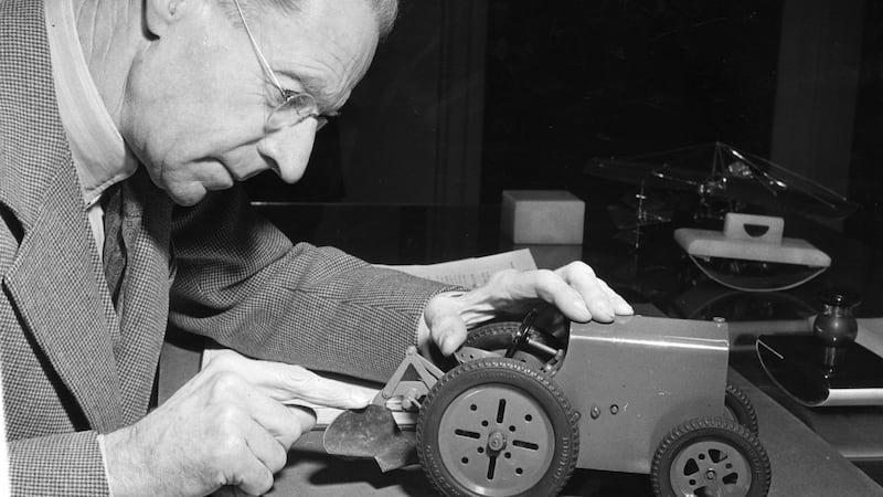 Irish engineer and inventor Harry Ferguson (1887-1950) in his study with his model tractor. Photograph: Fred Ramage/Getty Images