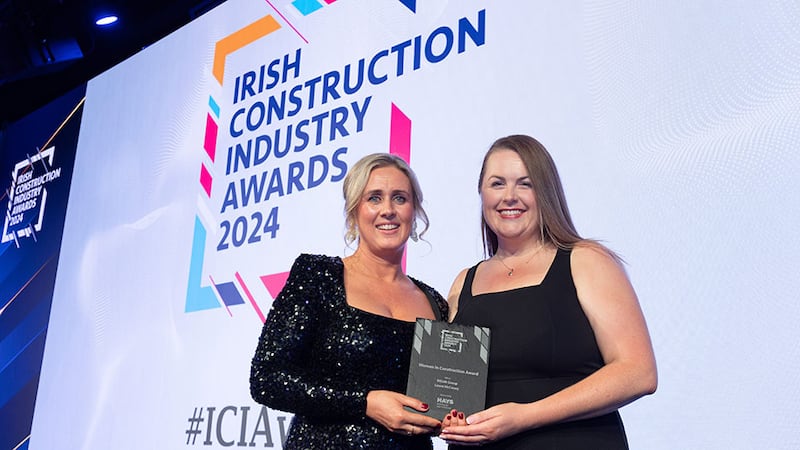 Anne-Marie Walsh, business director at Hays Ireland, presents the women in construction award to Laura McCooey, Elliott Group