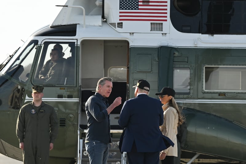 California governor Gavin Newsom speaks to president Donald Trump and first lady Melania Trump at Los Angeles International Airport in Los Angeles, California. Photograph: Kenny Holston/The New York Times
                      