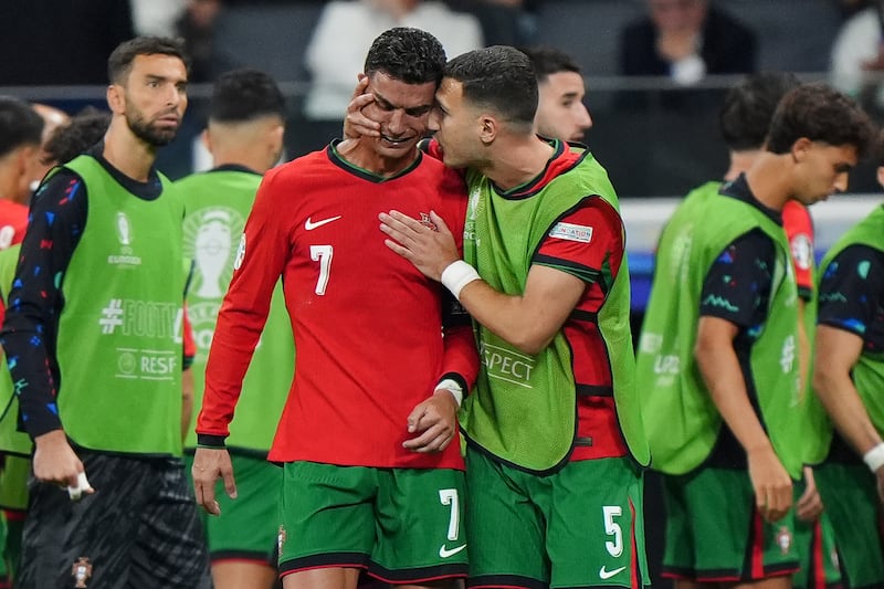 Portugal's Cristiano Ronaldo is consoled by Diogo Dalot at half-time. Photograph: Bradley Collyer/PA Wire