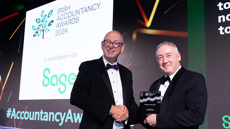 Anthony Casey, director, ETL Global, presents the employer of the year award to Dominic Kelly, Strata Financial