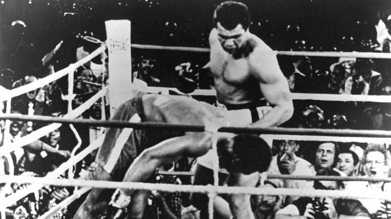 Muhammad Ali (right) watches   George Foreman go down during their world heavyweight boxing title fight in Kinshasa, Zaire, in 1975. Photograph: Getty Images