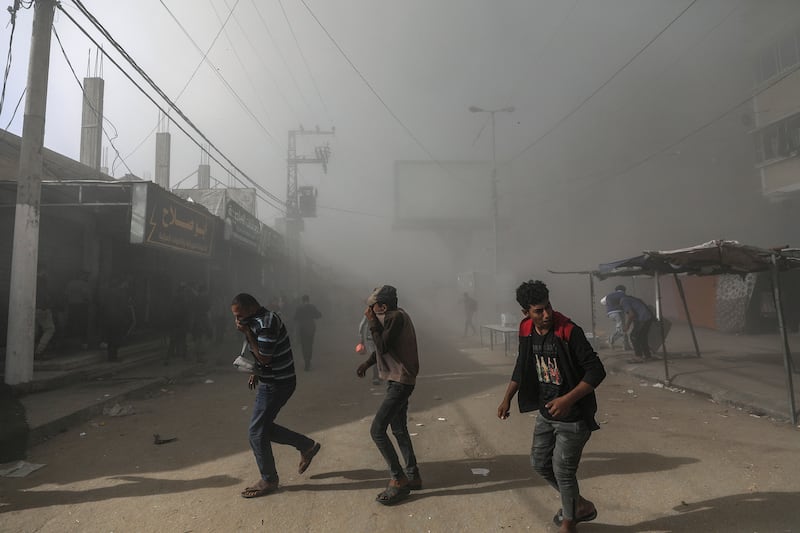 Palestinians take cover as smoke rises following an Israeli air strike on the Al Farouq Mosque in the Al Nuseirat refugee camp in the central Gaza Strip on November 23rd. Photograph: Mohammed Saber/EPA-EFE