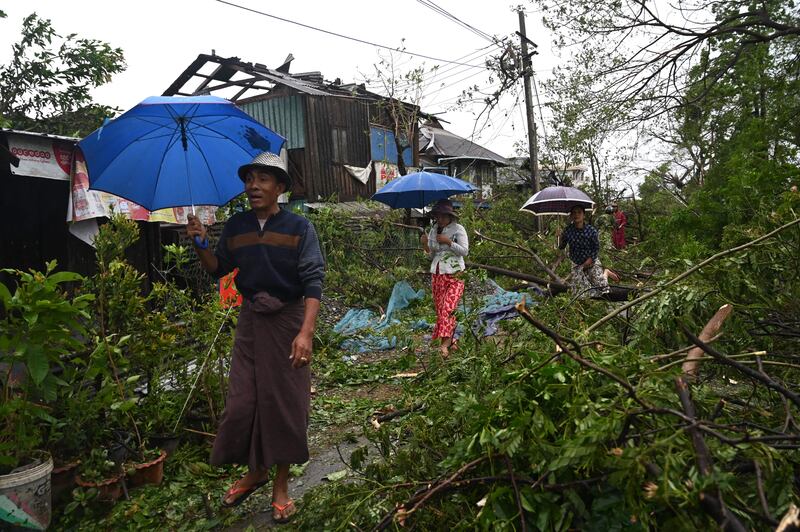 Local residents walk past the fallen trees after Cyclone Mocha hit Kyauktaw in Myanmar's Rakhine state on May 14th. Photograph: Sai Aung Main/AFP via Getty