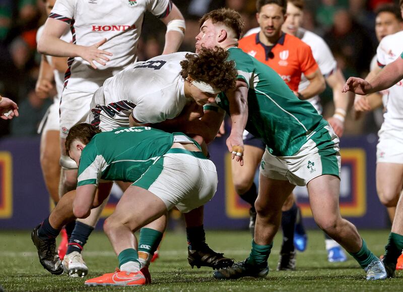 England's Nic Allison is tackled by Henry Walker and Eoghan Smyth of Ireland. Photograph: Andrew Conan/Inpho