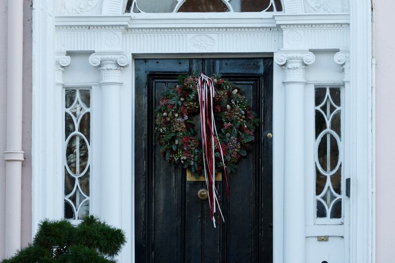 Front door: Natural wreath festooned with long velvet ribbons in pink and burgundy. Photograph: Nick Bradshaw