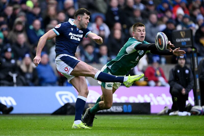 Blair Kinghorn of Scotland attempts to kick the ball clear but is blocked by Sam Prendergast of Ireland. Photograph: Stu Forster/Getty