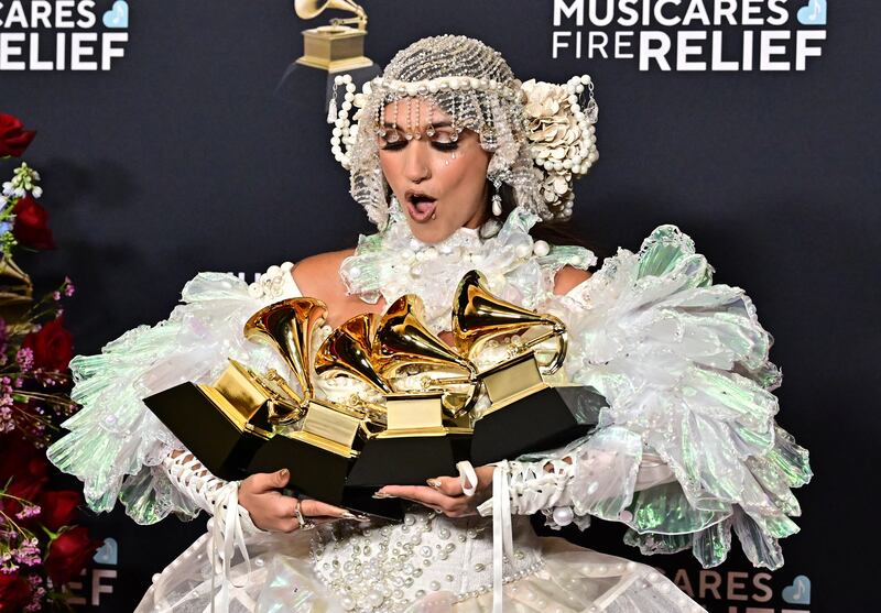 US singer Sierra Ferrell with the Grammys for Best Americana Album, Best Americana Roots Song, Best Americana Performance and Best Americana Roots Performance during the 67th Annual Grammy Awards in Los Angeles. Photograph: Frederic J. Brown/AFP/Getty Images