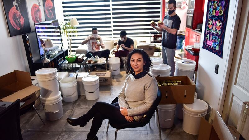 Yohana Agurto in her home in Santiago, Chile, where she packs her honey with her team. Photograph: Victor Ruiz Caballero/The New York Times