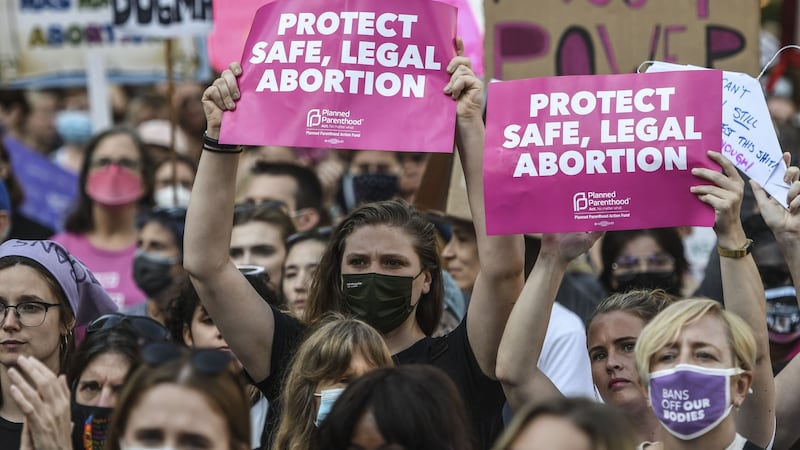 Demonstrators hold signs at a march in New York on Saturday. Photograph: Bloomberg