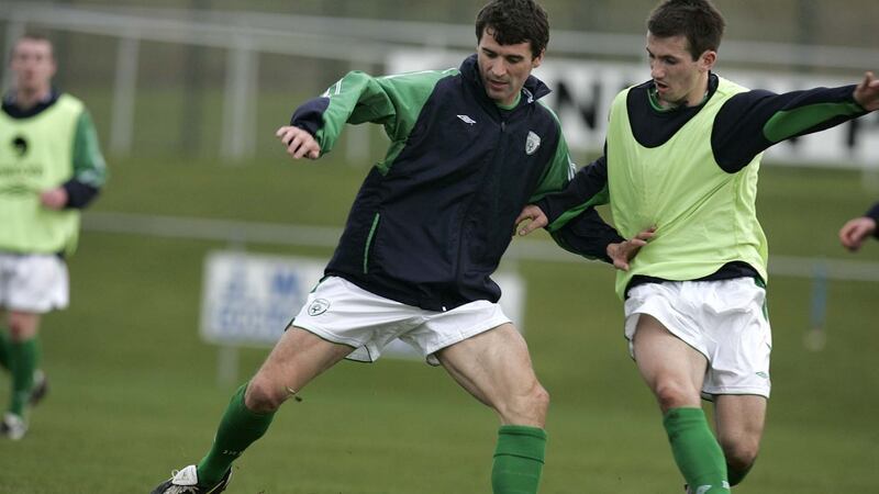 In a file photograph, Roy Keane and Liam Miller tussle during a Republic of Ireland training session in Malahide, Co. Dublin, on March  22nd, 2005. Photograph: Dara Mac Dónaill