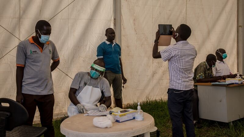 Truck drivers are photographed and their details are logged at the border between Uganda and South Sudan, which is closed for everyone except cargo truck drivers. Photograph: Sally Hayden