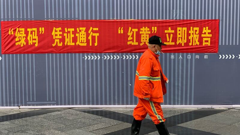 A propaganda-style banner reminding travellers of the rules at the subway in Hangzhou, China. The banner reads: ‘Green code, travel freely. Red or yellow, report immediately.’ Photograph: Paul Mozur/The New York Times