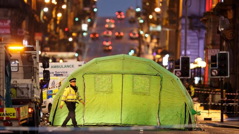 Investigators inspect the site of a fatal accident in George Square in Glasgow on Monday. Photograph: EPA