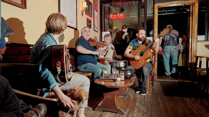 Background, from left: Tony DeMarco, Arthur DeMeo, and Matt Diaz play at the 11th St Bar in New York.