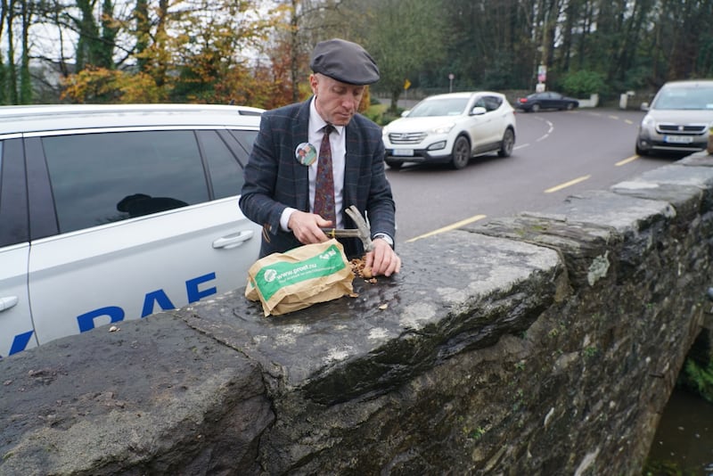 Michael Healy Rae takes a break from the campaign trail to hammer nuts on a bridge in Milltown, Co.Kerry. Photograph: Enda O’Dowd