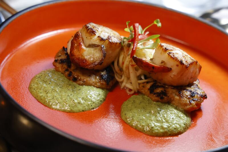 Indochine's grilled scallop, Isaan spice sausage, coriander and cashew yoghurt, with green papaya and mango salad. Photograph: Nick Bradshaw 