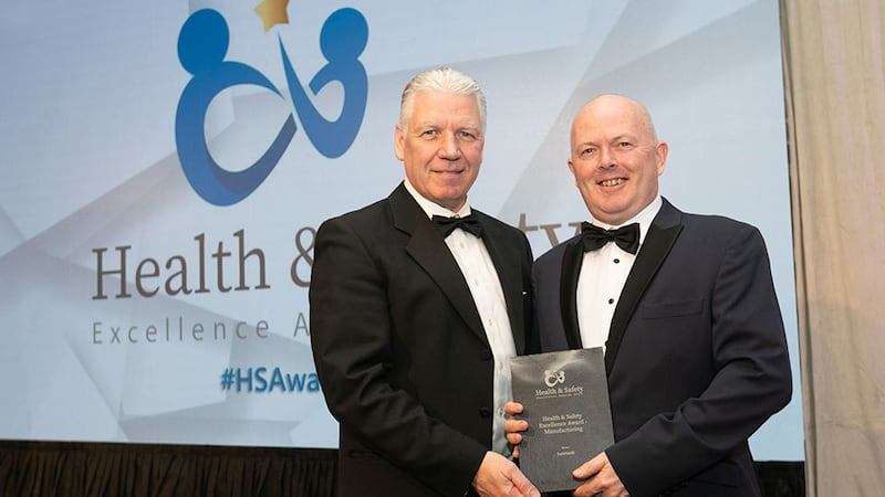 Eric Doyle, managing director at ISS Facility Services Ireland, presents the Health & Safety Excellence Award - Manufacturing to Niall Donnelly, Suretank