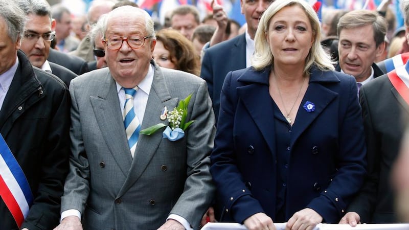 Jean-Marie Le Pen, former president of the National Front, and his daughter and actual president of the party Marine Le Pen take part in the party’s traditional May Day rally in Paris in 2014. Photograph: Yoan Valat/EPA