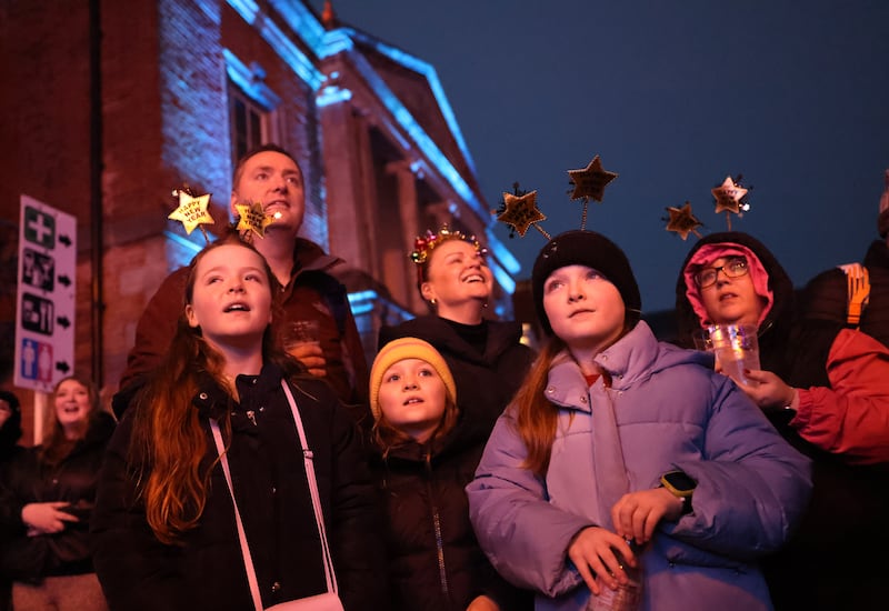 Ella and Grace Berkery and Gladys Adams (centre) with parents Martina and Niamh at Dublin Castle on New Year’s Eve. Photograph: Dara Mac Dónaill






